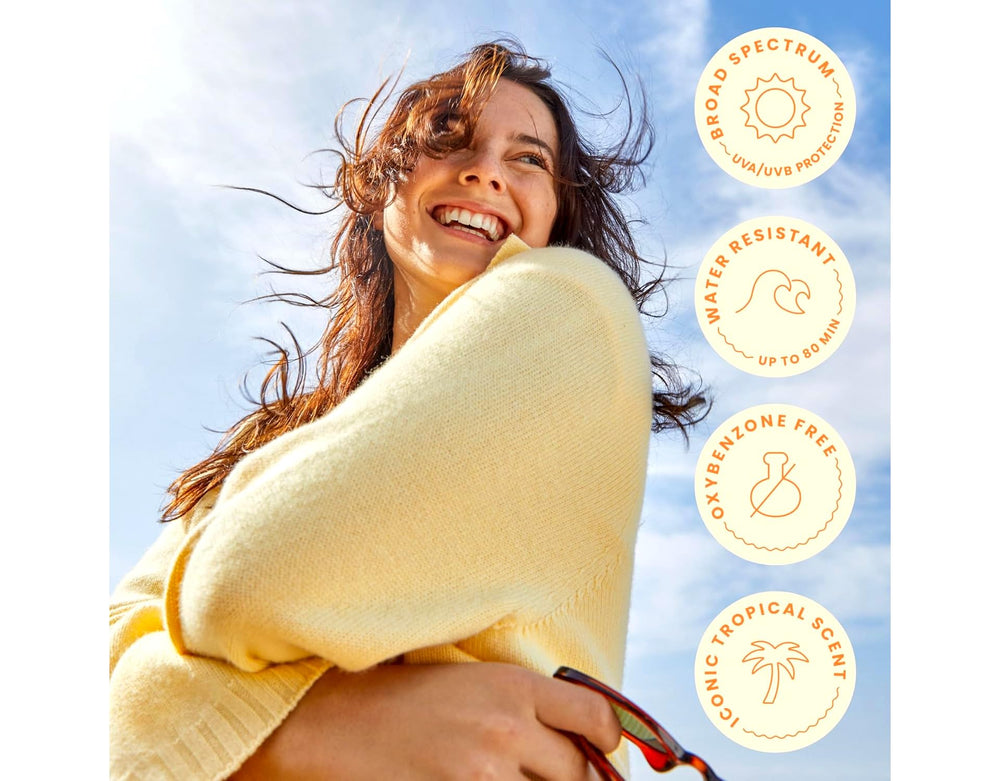 Hawaiian Tropic bottle on poolside towel lifestyle shot suggesting outdoor protection