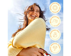 Hawaiian Tropic bottle on poolside towel lifestyle shot suggesting outdoor protection