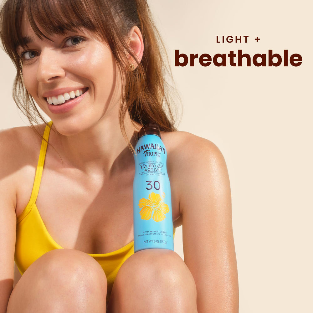 Hawaiian Tropic clear spray mist on skin demonstrating non-greasy finish