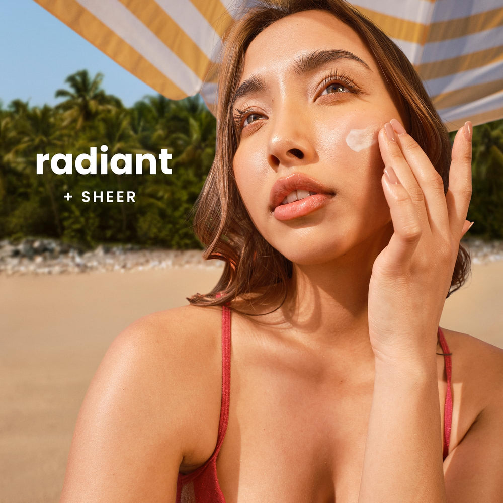 Hawaiian Tropic applied on hand demonstrating clear, non-greasy blend