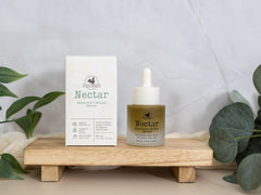 Hearth and Homestead bottle beside coin for scale showing compact 1 fl oz travel-friendly size