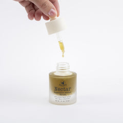 Hearth and Homestead serum on hand illustrating lightweight absorption and moisturizing benefit