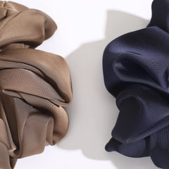 Helamvly scrunchie in a low bun illustrating polished look benefit suitable for events