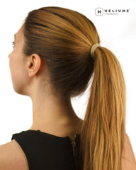 Heliums color swatch next to blonde hair showing natural blend and concealment