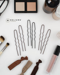 Heliums pins beside hair tools lifestyle shot showing professional-ready performance