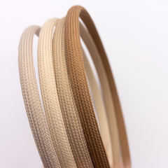 Heliums stacked headbands next to ruler for scale showing thin profile benefit easy storage and portability