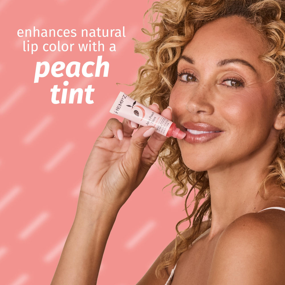 Hempz lip balm held in hand showing compact size and easy portability