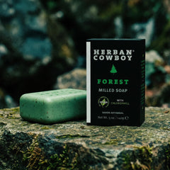 Herban Cowboy flatlay with cedar, mandarin, pepper illustrating natural fragrance notes