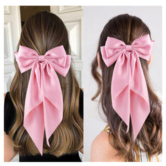 hisial bow worn in ponytail adds polished feminine finishing touch
