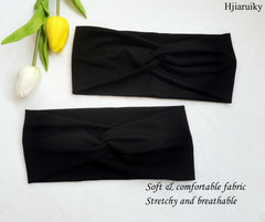 Hjiaruiky headband beside a hand for scale showing comfortable size and width