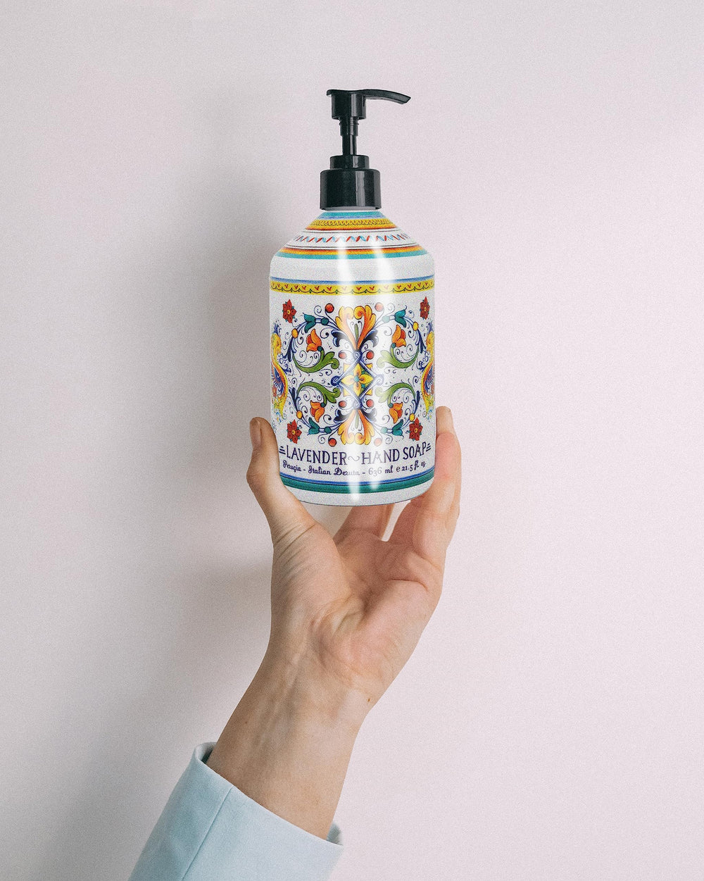Home & Body Company Perugia Deruta next to a hand towel to show 21.5 fl oz bottle scale and long-lasting value