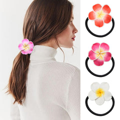 Honbay hair tie next to a coin for scale, shows flower and loop size