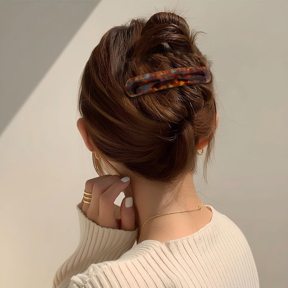 Hotalisona barrettes styled on a desk next to outfit for outfit pairing