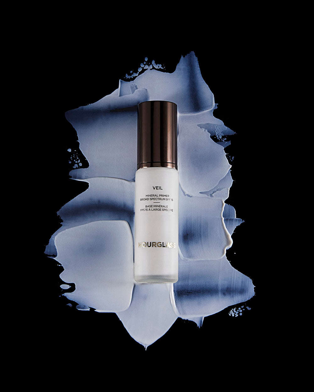 Hourglass Veil Mineral Primer in use on hand demonstrating smoothing effect and improved makeup adherence