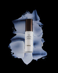 Hourglass Veil Mineral Primer in use on hand demonstrating smoothing effect and improved makeup adherence