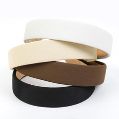 Huachi flatlay of black white beige brown headbands, coordinates with outfits