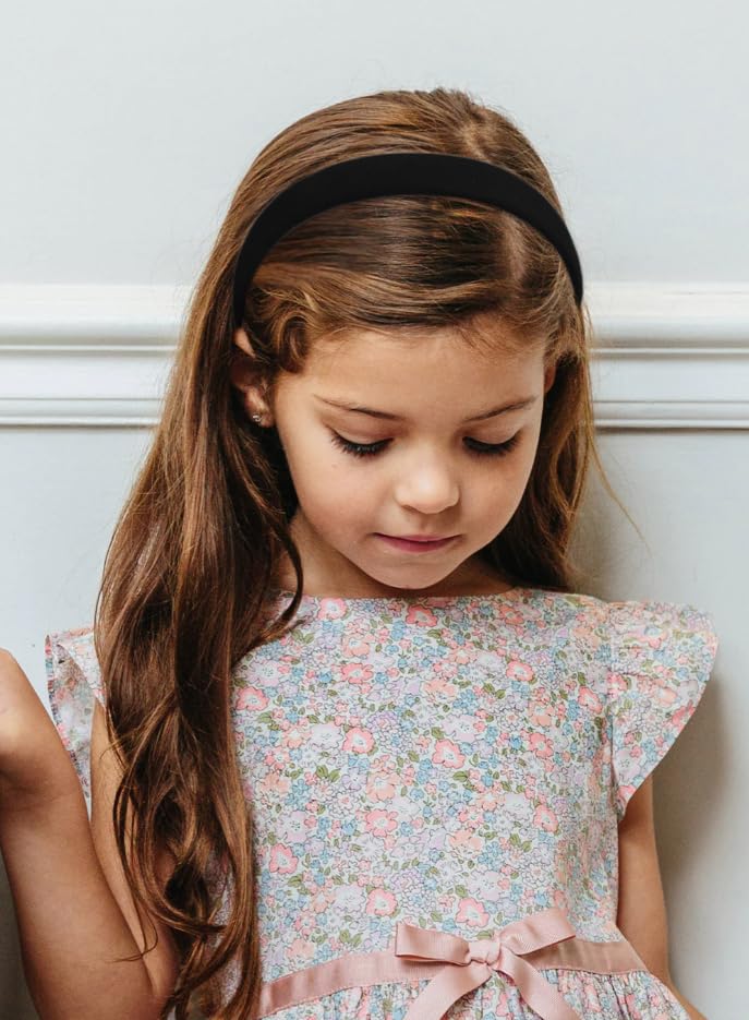 Huachi headband held in hand to show scale and lightweight comfortable wear benefit