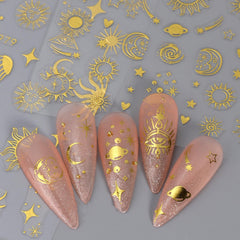 IDDFEVE finished manicure with gold suns and silver moons showing mixed-metal contrast benefit