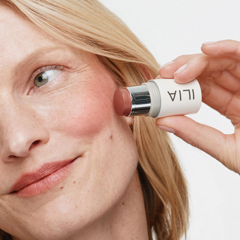 ILIA multi-stick being applied to lips showing natural tint and nourishing finish