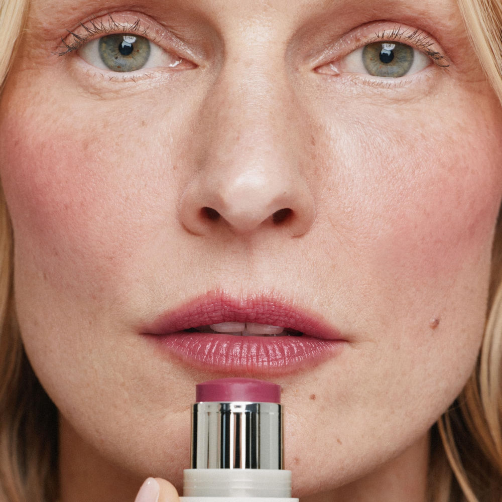 ILIA multi-stick applied to lips close-up for rich berry tint