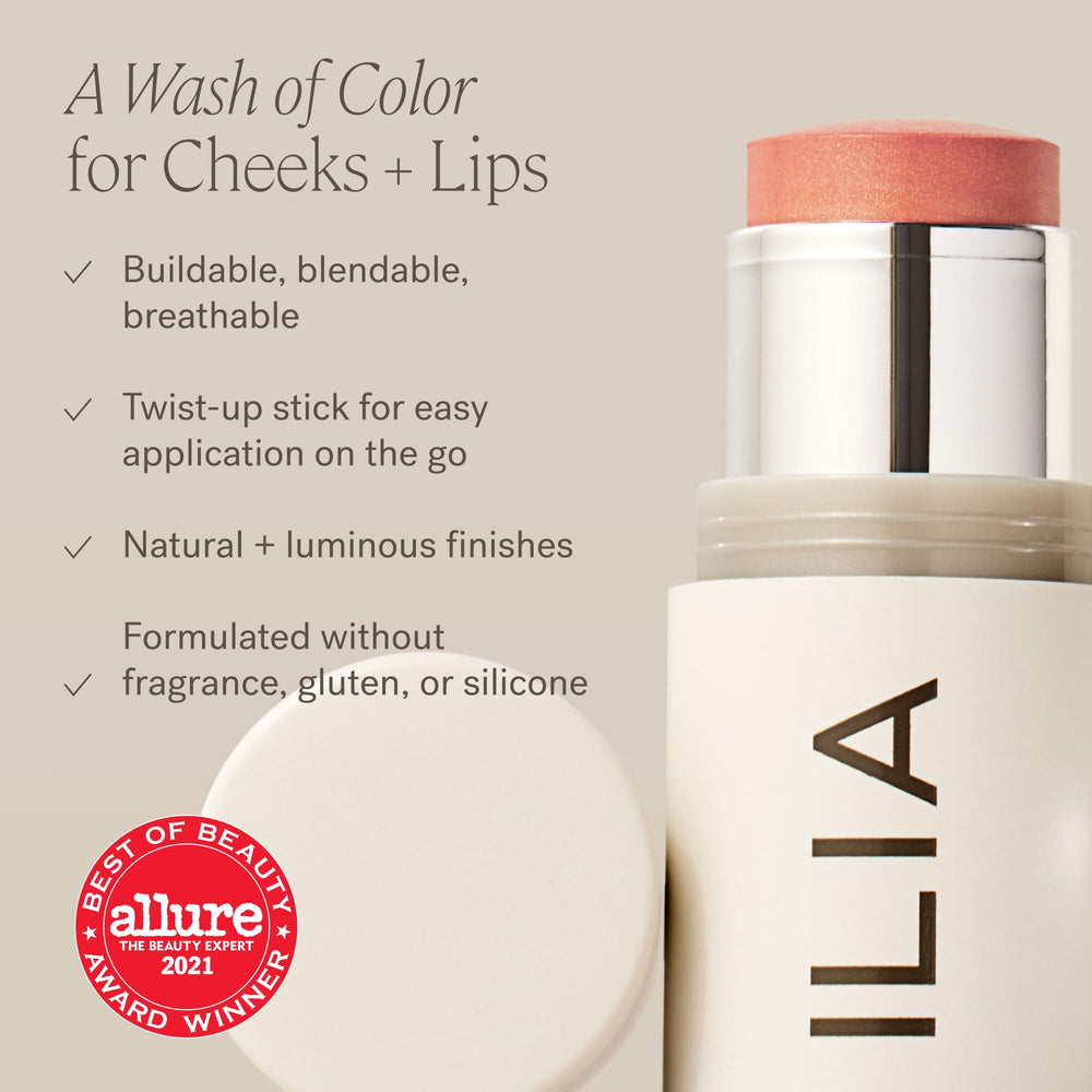ILIA multi‑stick held in hand to show size and portable everyday convenience