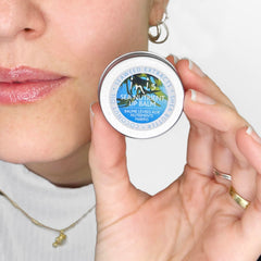 Inis Sea Nutrient Lip Balm lifestyle at beach showing portable tin and refreshing benefit