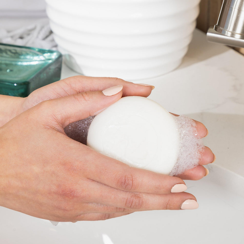 Lather of Inis soap in hand demonstrating rich creamy foam for gentle cleansing