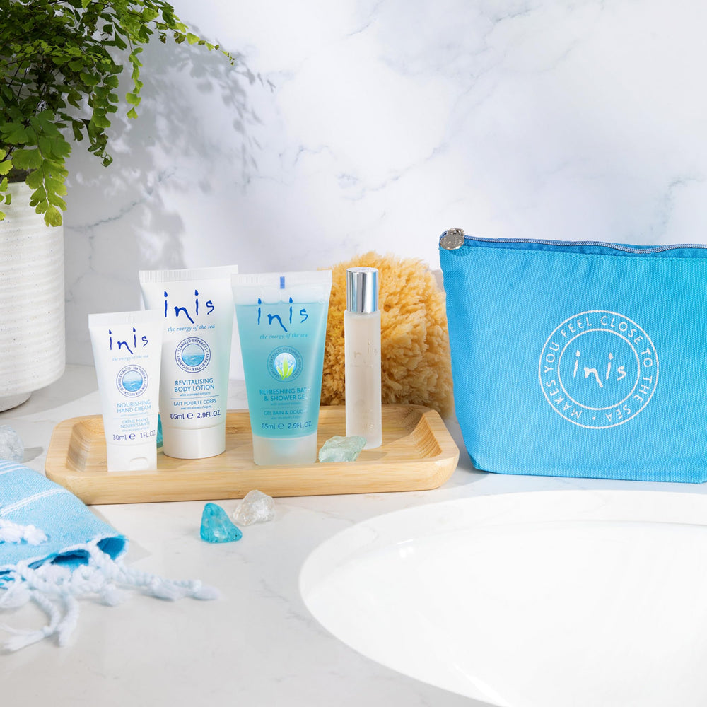 Inis voyager open cosmetic bag displaying all four travel-size products neatly