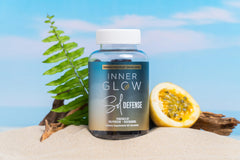 Inner Glow bottle next to travel items demonstrating compact, on‑the‑go use