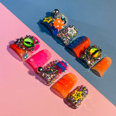 IntoVibes close-up of the orange barbell charm highlighting handcrafted detail benefit: eye-catching accents