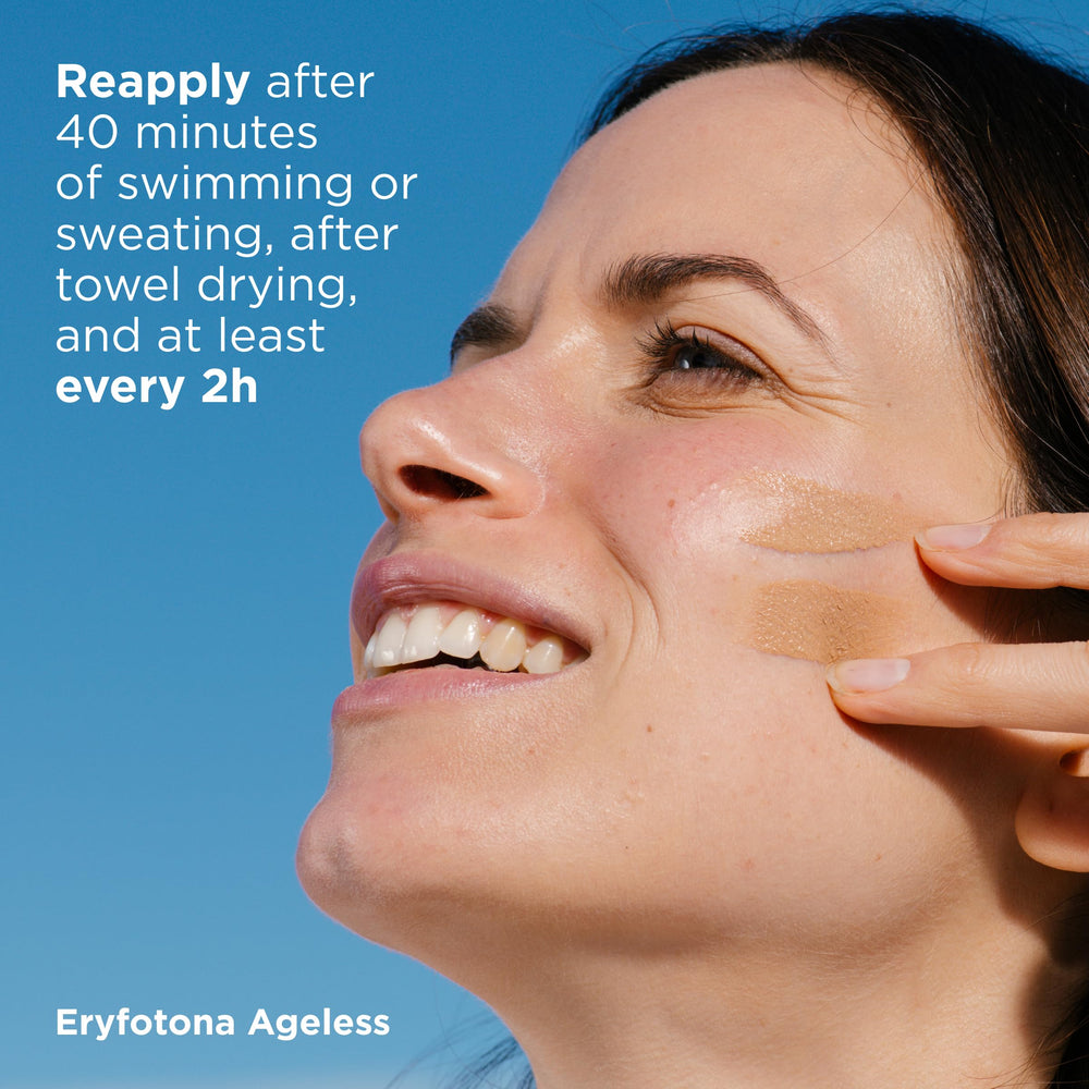 Person applying ISDIN Eryfotona Ageless outdoors illustrating daily sun protection