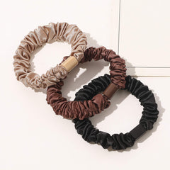 Ivyu scrunchie next to coin showing compact 2.7-inch size benefit