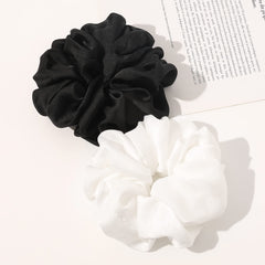 Ivyu scrunchie next to ruler showing extra-large size for bulky hair support