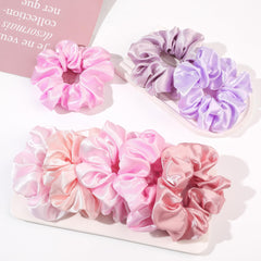Ivyu scrunchie next to a coin showing size for big ponytails and thick hair