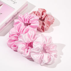 Ivyu scrunchie holding thick curly hair in a high ponytail for long-lasting style