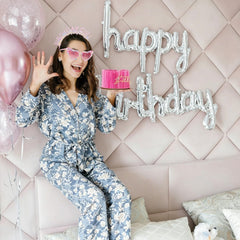 Jaciya kit on model smiling for celebratory photo-ready look