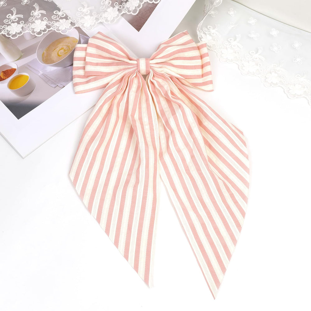 JGQUR bow held in hand showing scale and wearable size for styling convenience