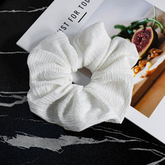 JGQUR scrunchie holding a messy bun without creases or pulling