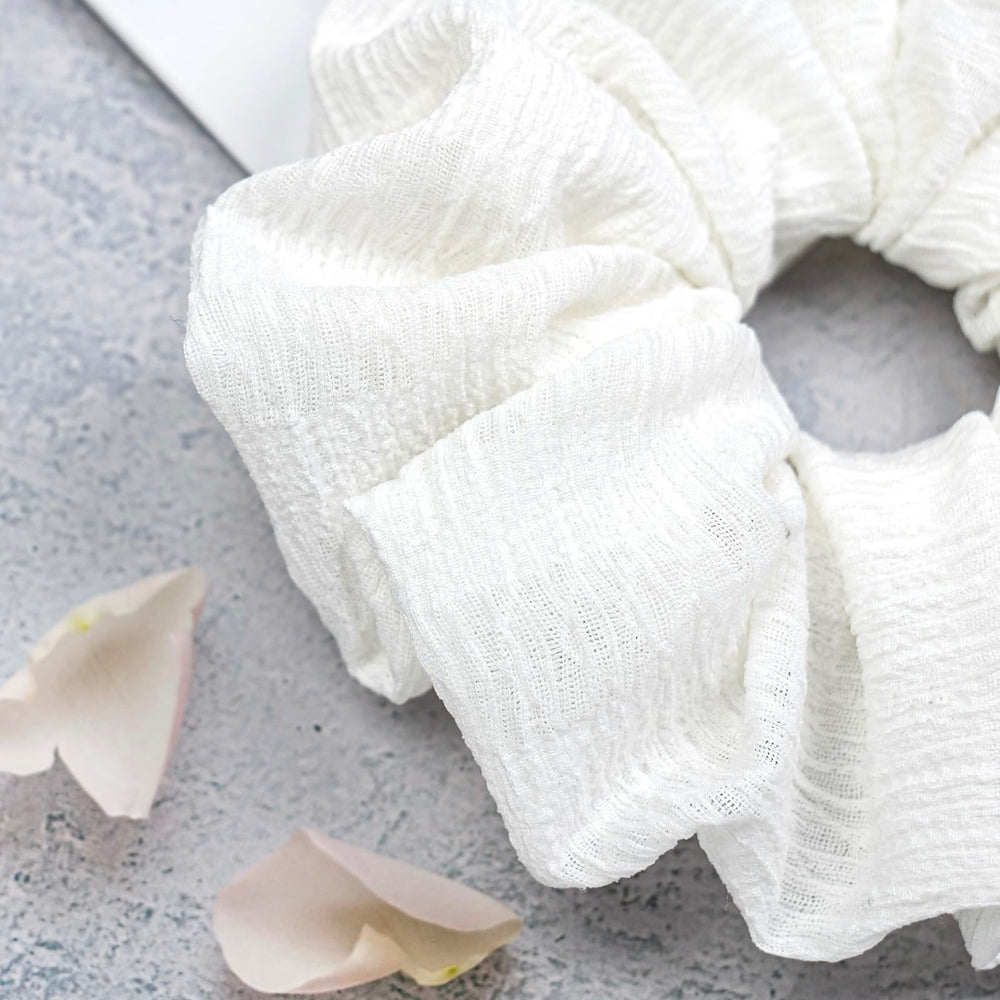 JGQUR scrunchie securing a high ponytail with visible volume