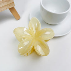 Jinshining front view of creamy yellow plumeria clip adding tropical flair
