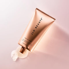 JLO BEAUTY 5 oz tube in hand showing travel-friendly size and convenience