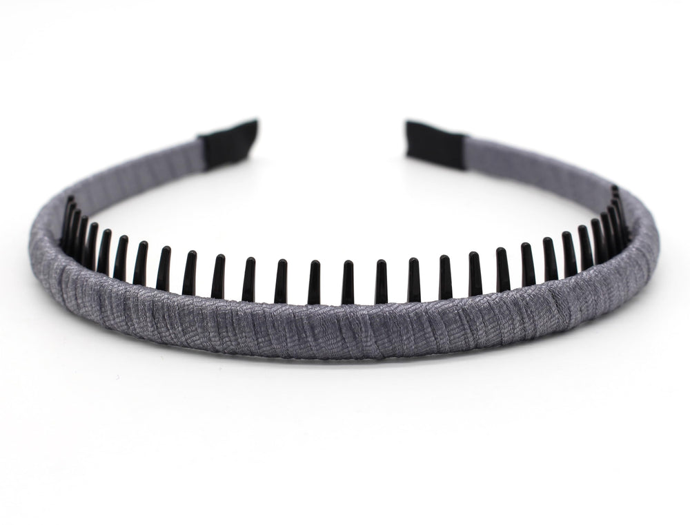 JOBAND hairband next to hand for size comparison highlighting slim profile