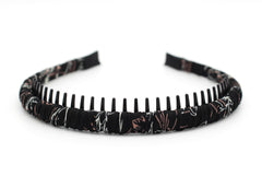 JOBAND headband in hand to show scale and lightweight wearability benefit