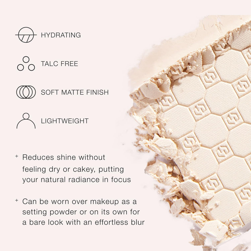 Jouer applying powder with brush to T-zone showing smooth application and shine control