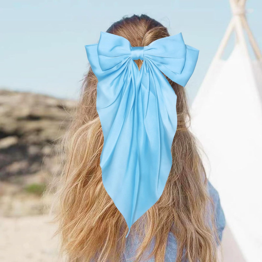 JOYRUBY bow held in hand to show scale and size for styling