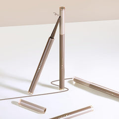 JUDYDOLL eyeliner placed on vanity with brush, suggesting daily routine and travel convenience
