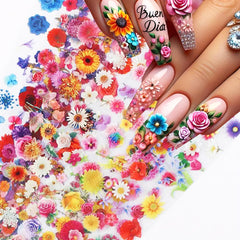 juggssa finished spring manicure on hands showing floral foils sealed with glossy top coat
