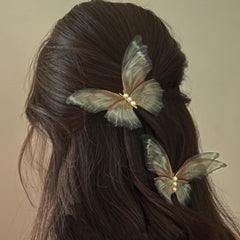 Jumwrit front view of two green butterfly clips showing decorative pearls and shape, elegant accent