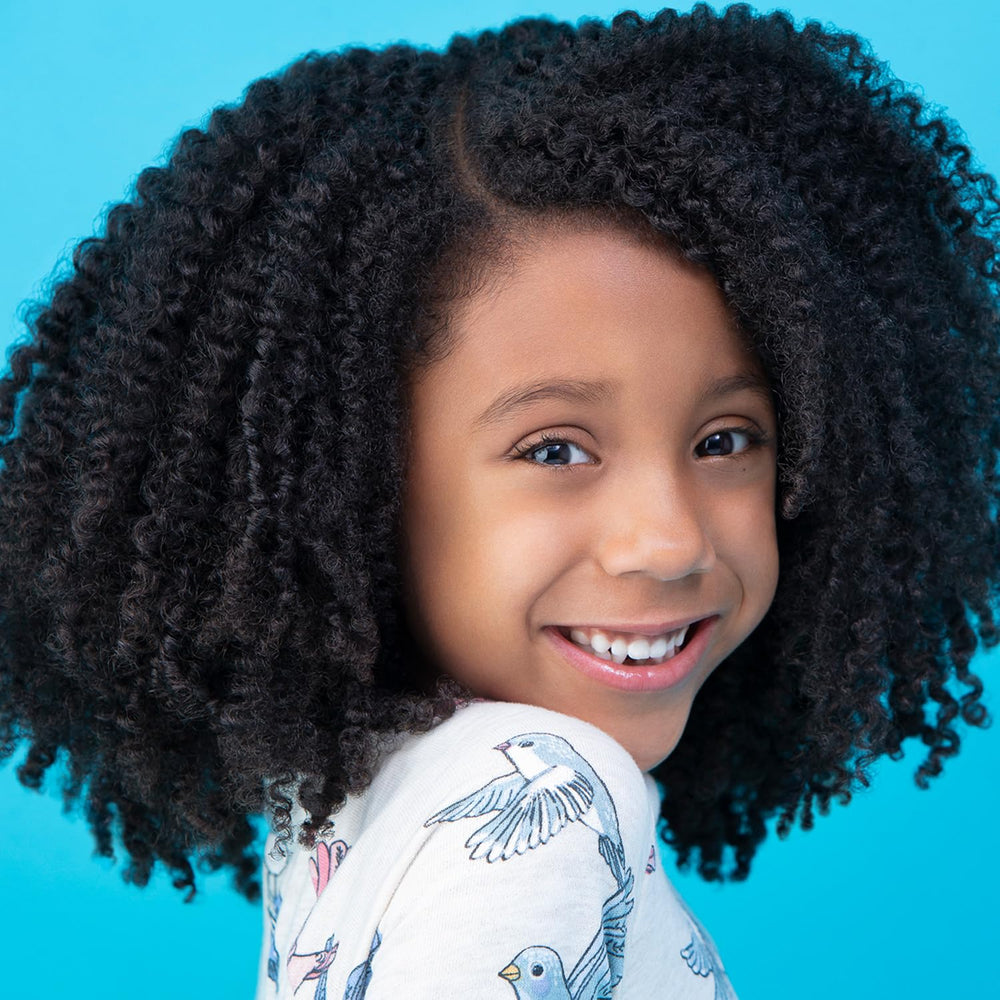 Styled braid-out on child after using Just For Me illustrating long-lasting definition