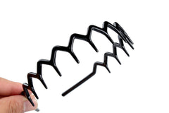 KALIYOTO headband held in hand for scale, showing slim travel-friendly size and sturdiness